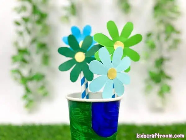 Four paper Earth Day Daisy Flowers. Made from recycled paper and paper straws.