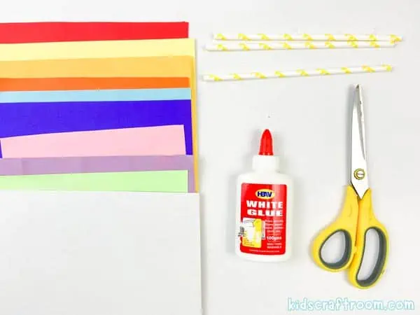 Craft supplies needed to make spring flowers. Colorful papers, straws, scissors and glue.