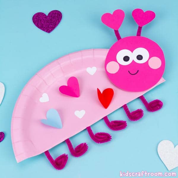 A close up of a pink paper plate love bug craft. 